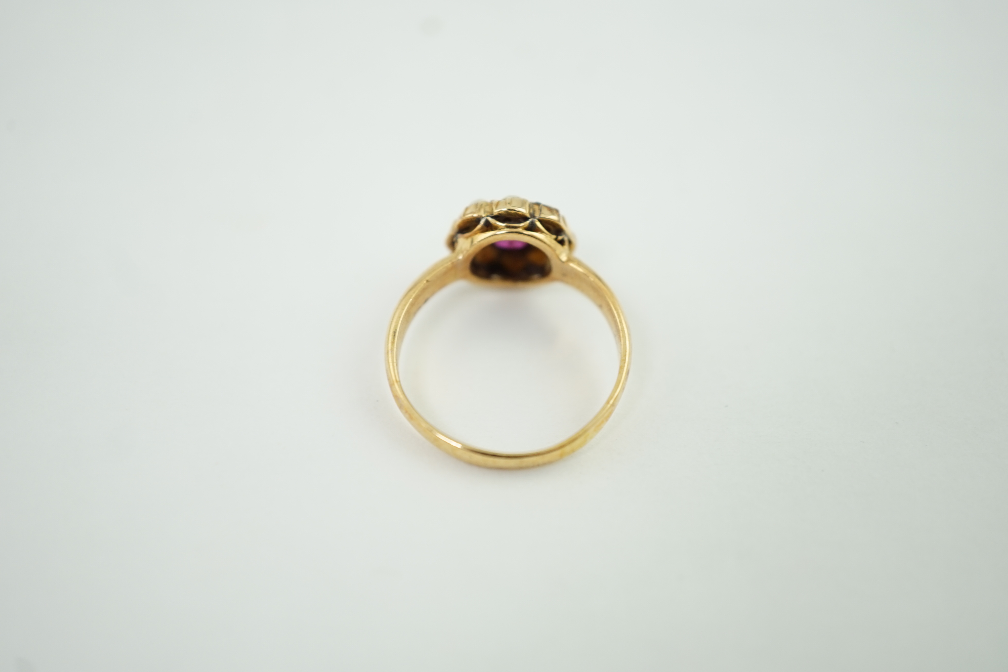 A gold, ruby and split pearl cluster ring